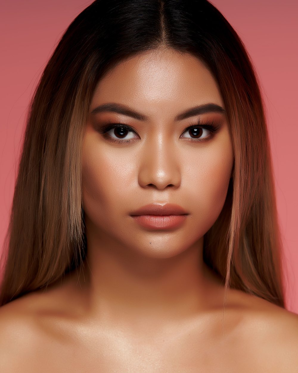 Beauty campaign showcasing a model with a dewy skin look and minimal makeup, emphasizing natural radiance and a fresh, effortless beauty in a clean and elegant setting.