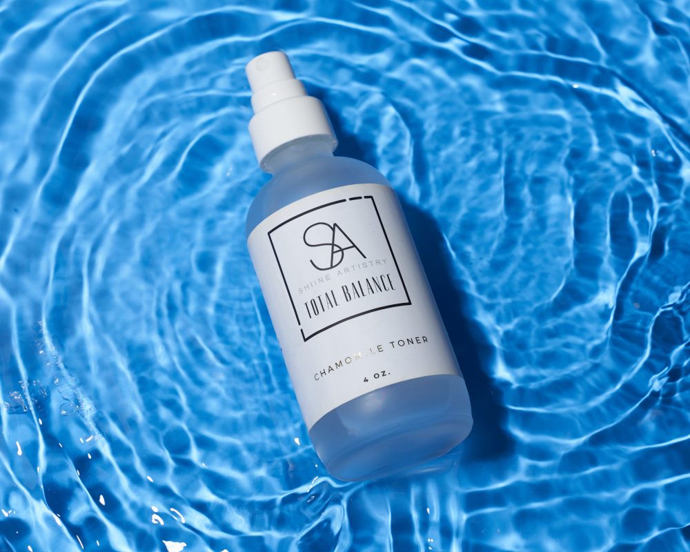 Skincare product featured in flowing water, highlighting its purity and freshness with dynamic motion and elegant presentation in a natural setting.