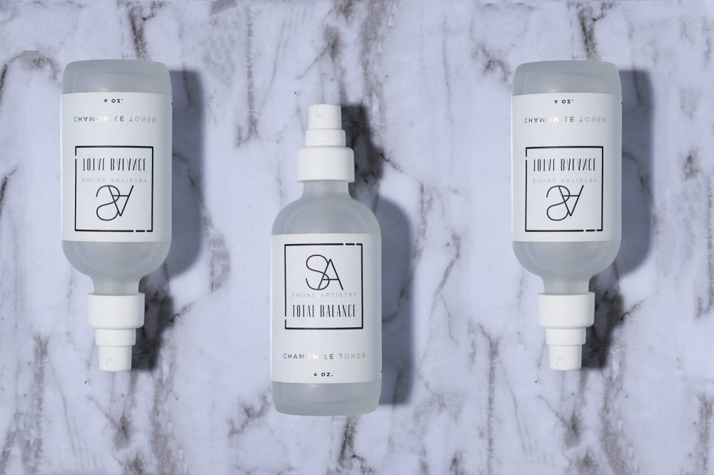 Creative campaign featuring multiple shots of the same skincare product arranged on a marble surface, showcasing the product's elegance and luxurious packaging with a sophisticated backdrop.