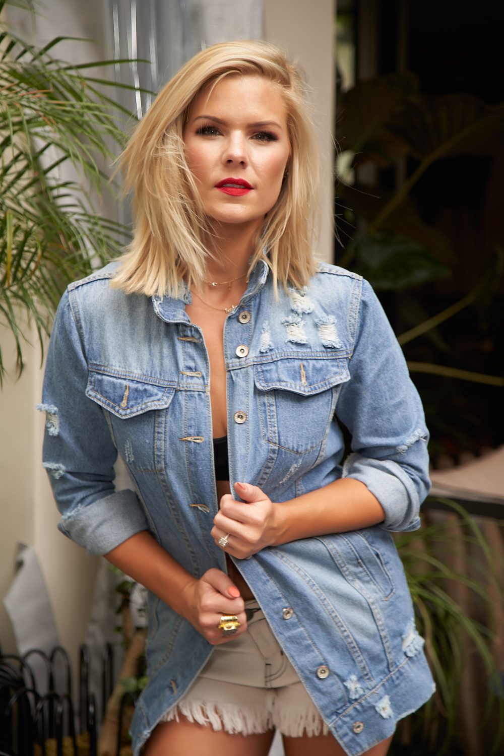 Jean jacket campaign featuring a model looking directly into the camera while wearing a stylish jean jacket, highlighting casual fashion and contemporary style in a trendy setting.
